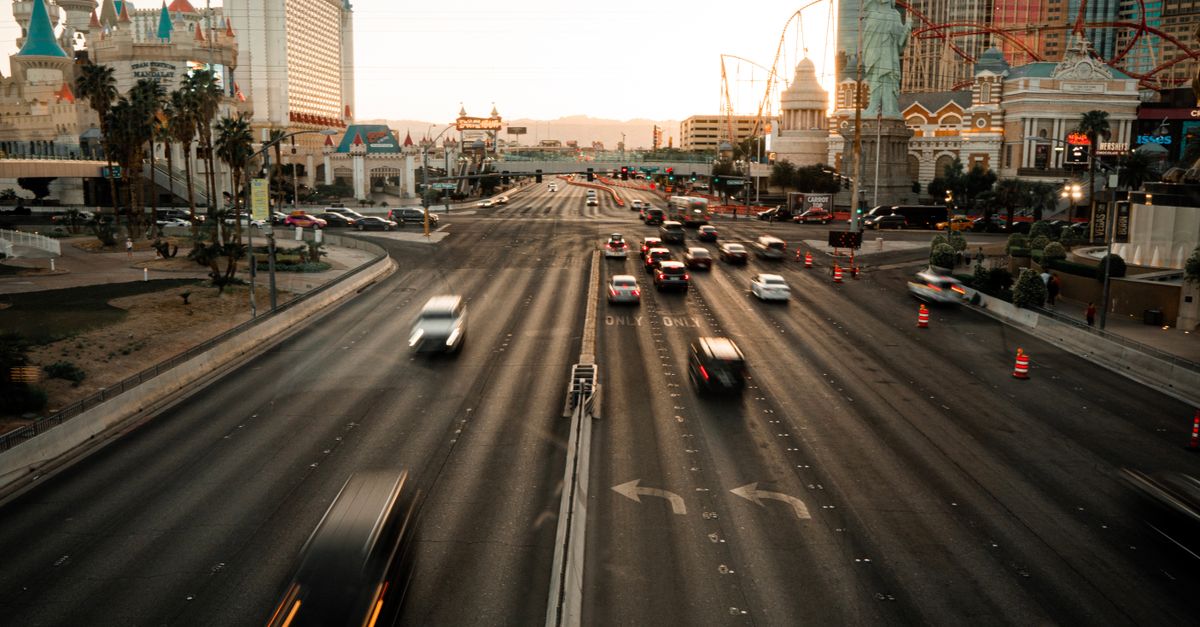 Aerial view of the busy Las Vegas Strip with iconic landmarks during sunset.