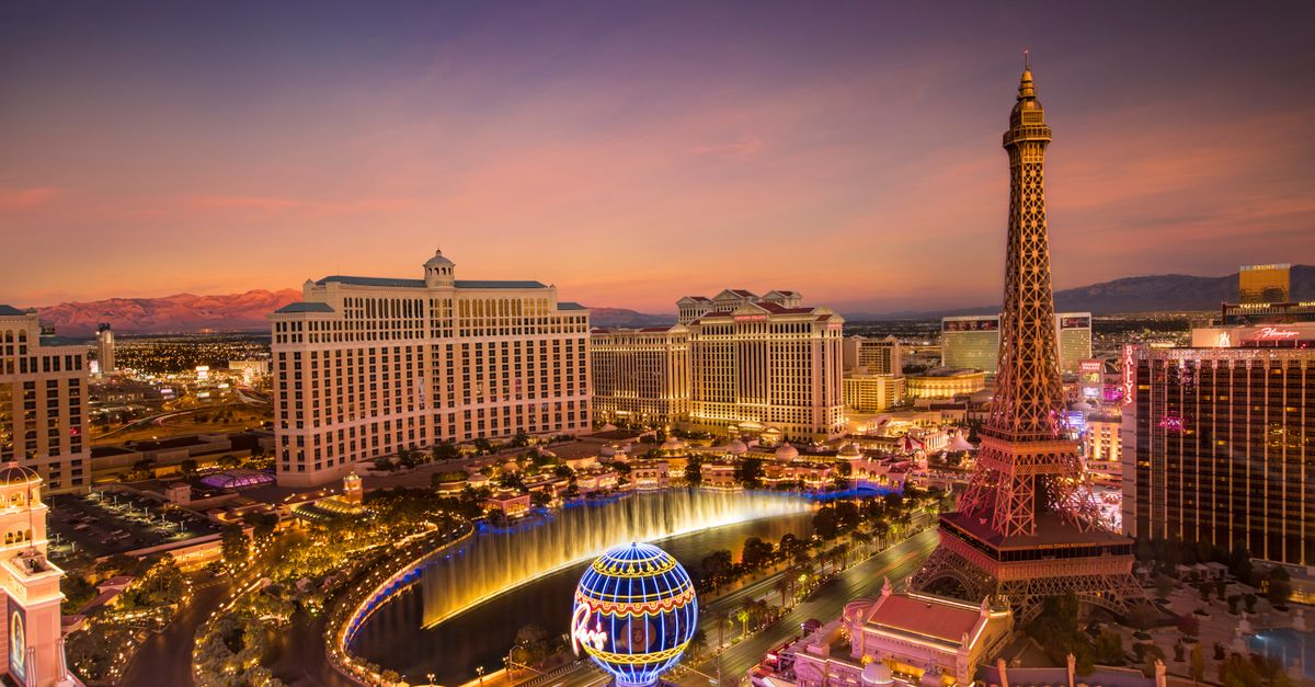 Stunning aerial view of Las Vegas skyline at sunset, featuring the Eiffel Tower and Bellagio fountains.